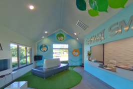 Colorful children's dental office with blue and green décor, modern furniture, and welcoming pediatric treatment space.